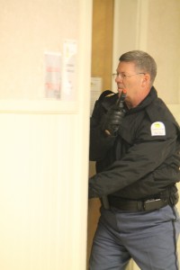 A Chattahoochee Technical College Campus Police officer checks a classroom during a past training scenario.
