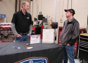 During an industry meet and greet hosted by Chattahoochee Technical College, Tim Lanier, owner of Killian Automotive in Canton, speaks to student Matthew Rollins about a future career in the automotive industry.