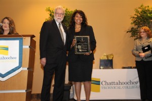 CTC President Dr. Ron Newcomb presents Instructor of the Year winner Celnisha Dangerfield with the award.