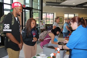 Chattahoochee Technical College students Anderson Layne of Acworth and McKenzie Joyce of Woodstock chat with Executive Director of Retention Services Lauren Lunk during the college’s “Suc-Seed at CTC” event. Students planted herbs and were encouraged to grow their own gardens.