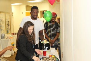 From left, CTC Director of Libraries Leigh Hall serves student Jordan Oliver during Wednesday’s open house. Student Chuma Onyeagba, right, looks on as he waits in line.