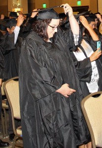 A recent graduate turns her tassel during commencement.