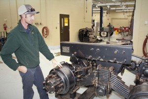 Photo of Diesel Equipment Technology instructor Evan Dover looking over a piece of training equipment.