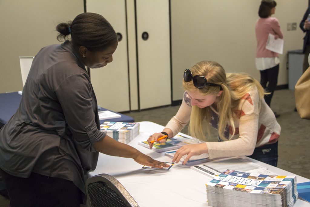 Recent Woodstock High School graduate Sarah Michelle DeAngelo, above right, checks out the Chattahoochee Tech Career Guide at the Mountain View Open House.