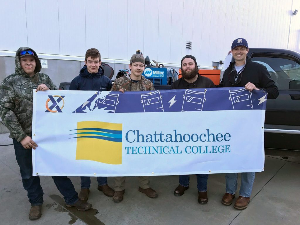 Shown here, l-r, are Chattahoochee Tech welding students Sam Stevenson, Tucker Highfield, Riley Cagle, Indigo Eadie with an event representative. Chattahoochee Tech welding students participating in this event also included Wes Lindsay and Isaac Williams.