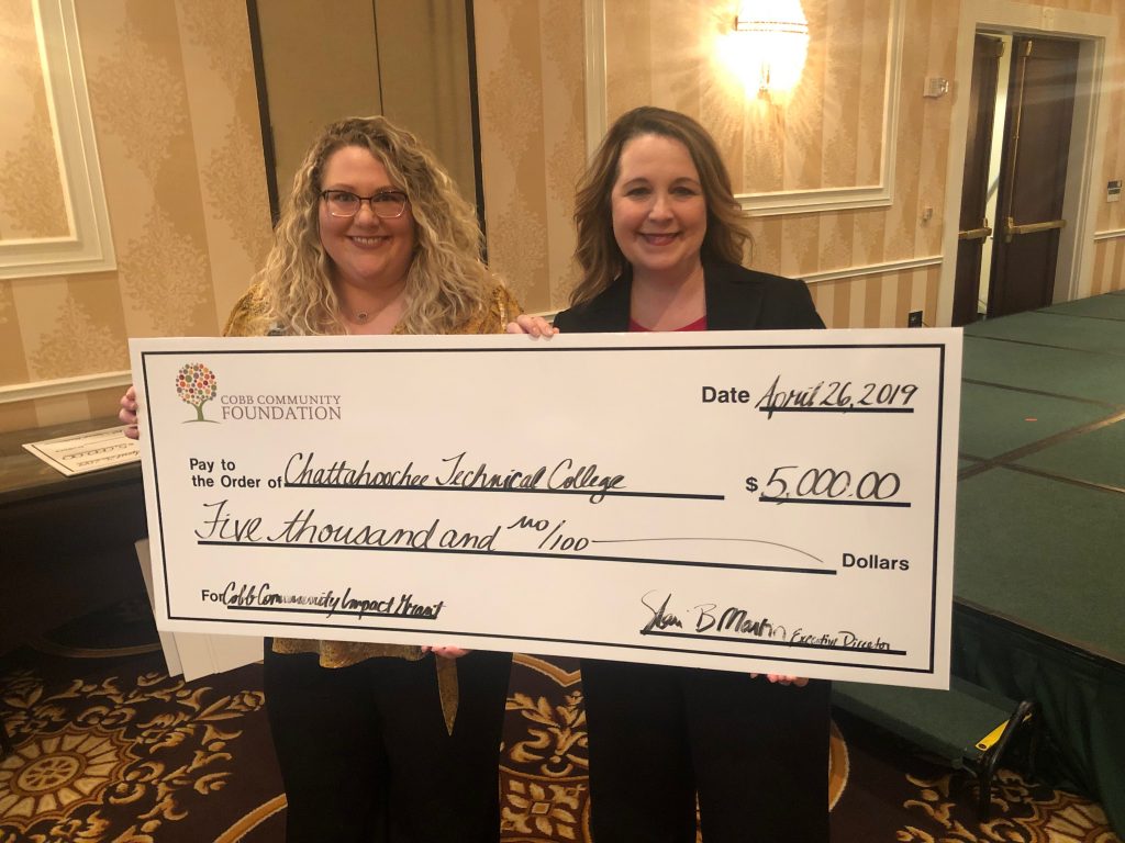 Receiving the grant check were Amanda Henderson and Stephanie Hubbell.