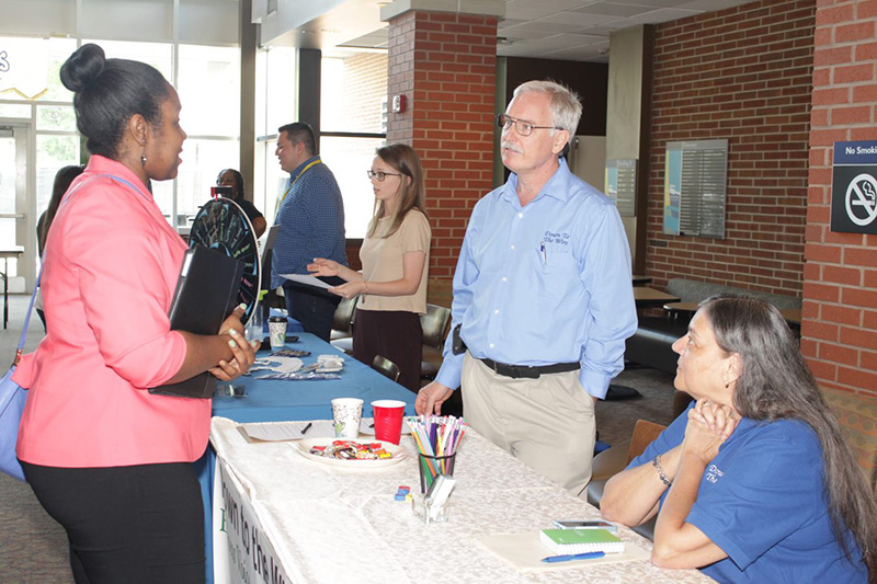 Men and women talking at Business and Technology Job Fair