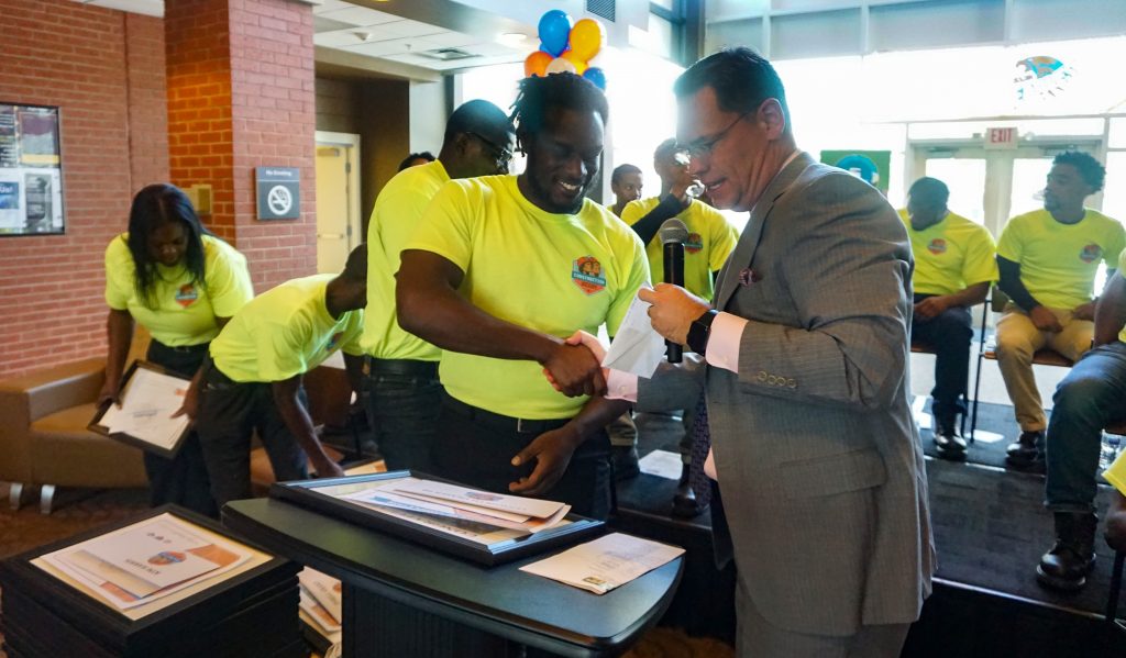 CEFGA President and CEO Scott Shelar congratulates the Construction Ready Program 1,000th graduate, Lenworth Fraser III.