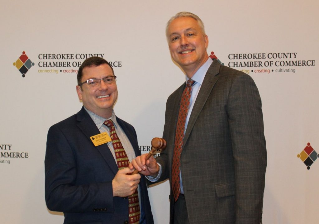 John Barker, the immediate past chairman of the board of directors for Cherokee Chamber of Commerce, passed the gavel to new the new chairman, David Simmons.