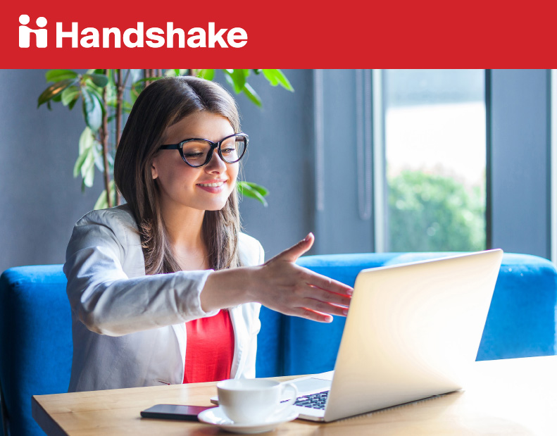 Handshake. Women extending her hand to shake the computer