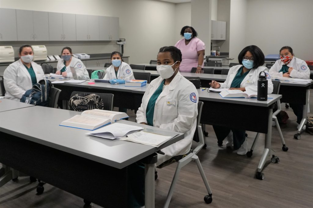 Medical Assisting Program Tenner, standing, leads class of Medical Assisting students.