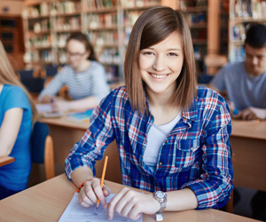 A woman student smiling in a library