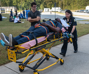 Emergency Medical students practicing moving a patient