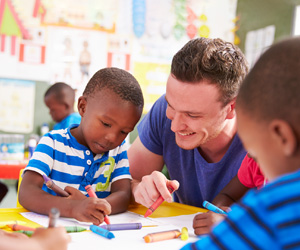 A male adult helping students