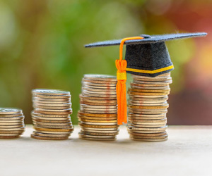 Graduation cap on top of coins