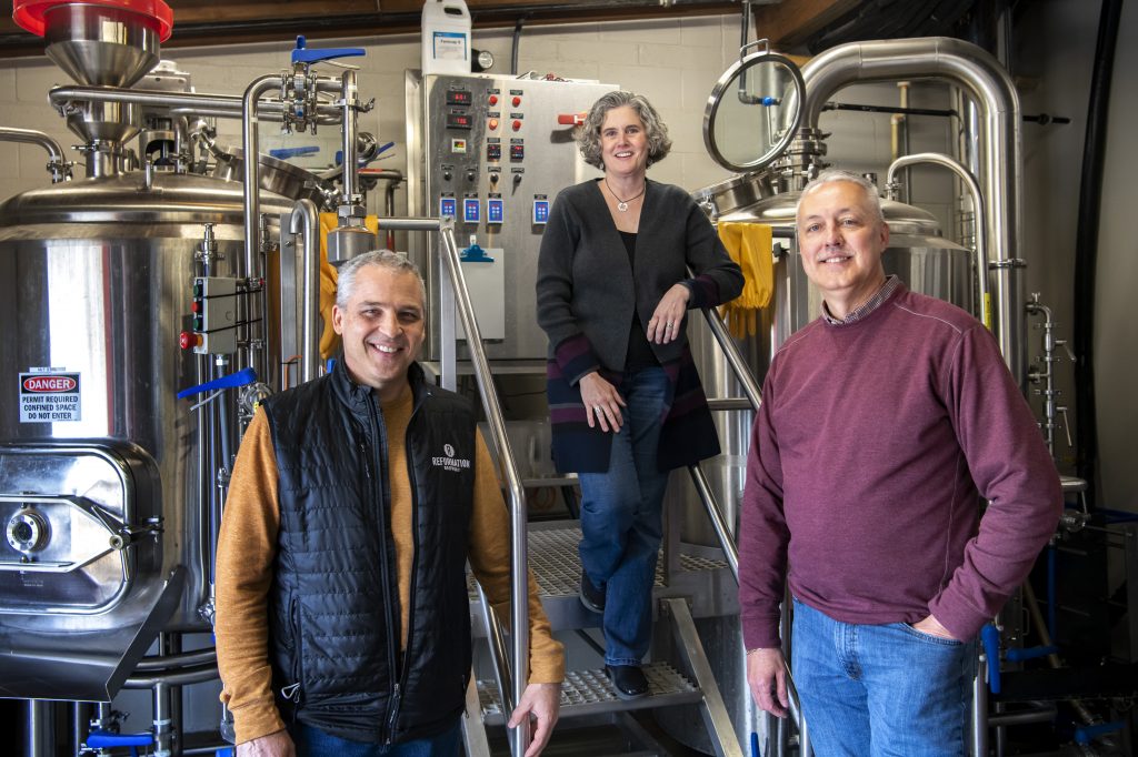 Nick Downs from Reformation Brewery in Woodstock is consulting with Chattahoochee Tech on this project to develop the college's Brewing & Fermentation Production Technology program. Shown here, l-r, at Reformation Brewery are Nick Downs, Chattahoochee Tech Dean Marcy Smith, and Chattahoochee Tech Vice President of Facilities David Simmons.