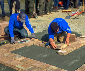 Two men laying brick