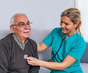 Nurse working with an elderly man