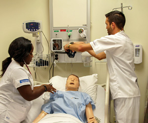 Two nurses practicing on a mock patient