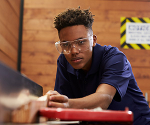 Student working with metal