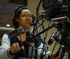 African American woman working camera