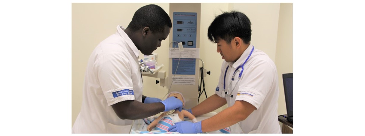 African American and Asian Nursing students practicing