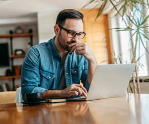 Man working at desk with laptop computer