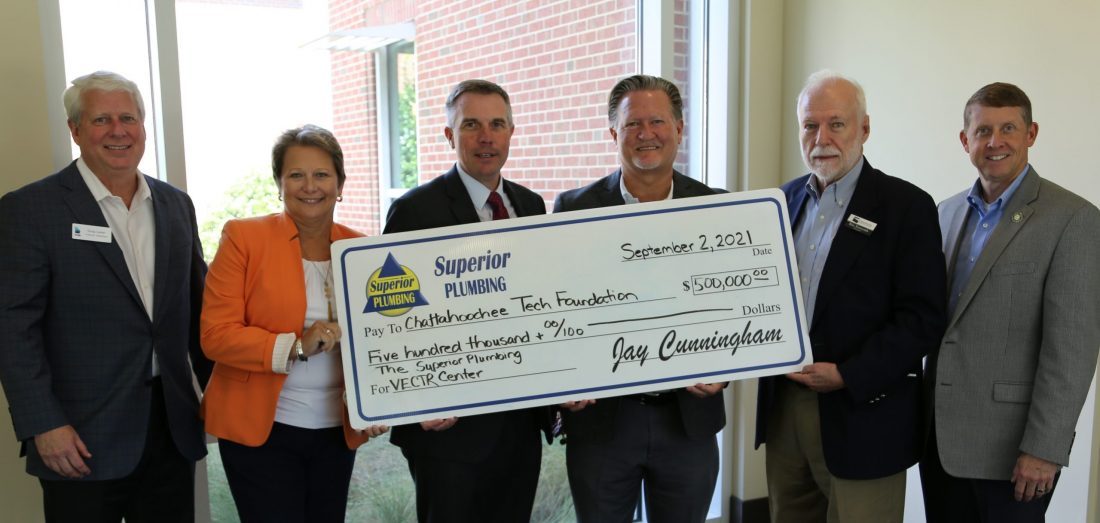 Veterans Center group photo with check