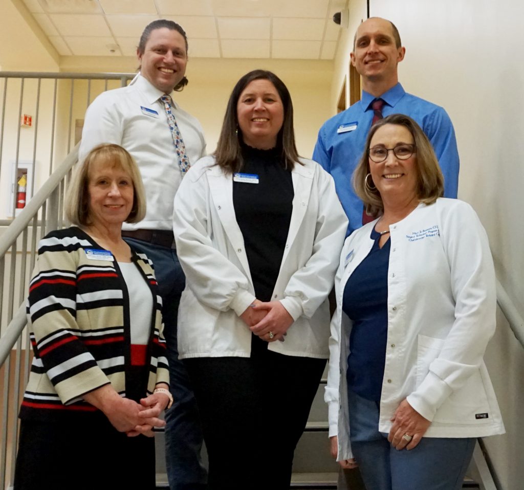 Shown here in the front row, l-r, are Clinical Laboratory Technology Program Director Robin Aiken, Radiography Program Director Jamie Bailey, and Surgical Technology Program Director Mary Jo Bergman. On the back row, l-r, are Physical Therapist Assistant Program Director Aaron Freeman and EMS Professions/Paramedicine Program Director Ryan Dehnert.