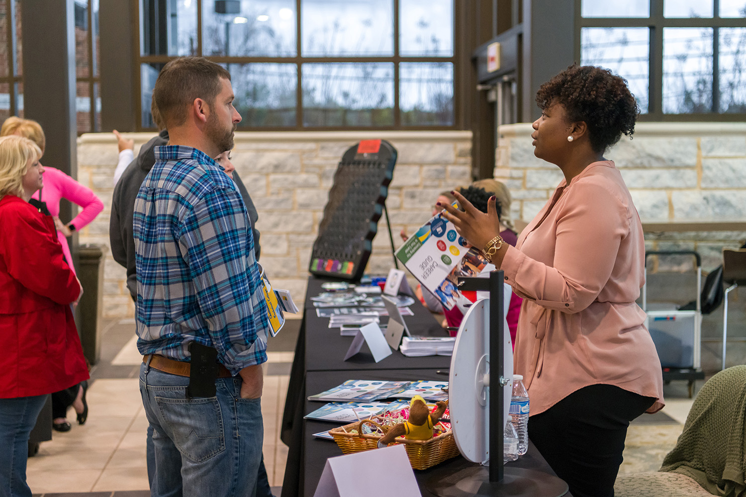 Admissions counselor helping a future student at open house