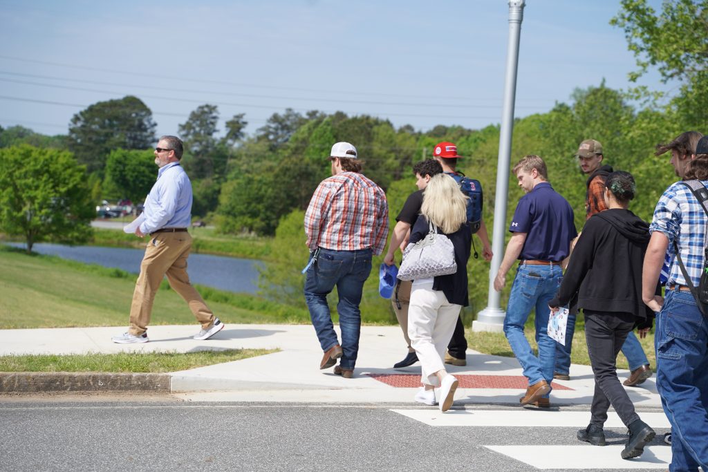 Jason Tanner leading a group of high school students on a tour of the North Metro Campus