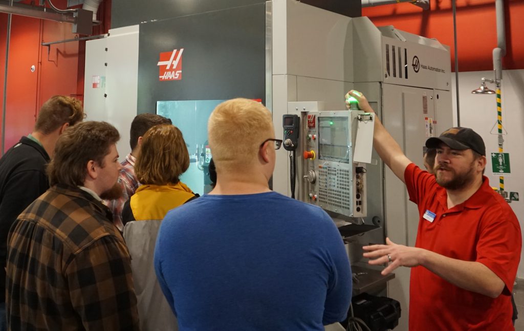 Chattahoochee Tech Precision Machining and Manufacturing Instructor Wayne Plos is shown here talking with local high school students about the Computer Numeric Control (CNC) machines used for instruction at the college.