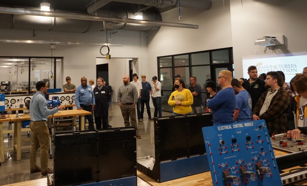 Chattahoochee Tech Electrical & Computer Engineering Technology Instructor Andrew Kazemian is shown here talking with local high school students touring the college's Center for Advanced Manufacturing.