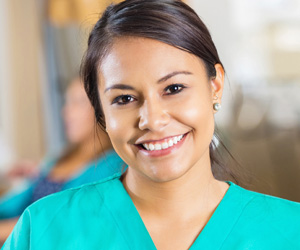 A nurse woman in scrubs smiling