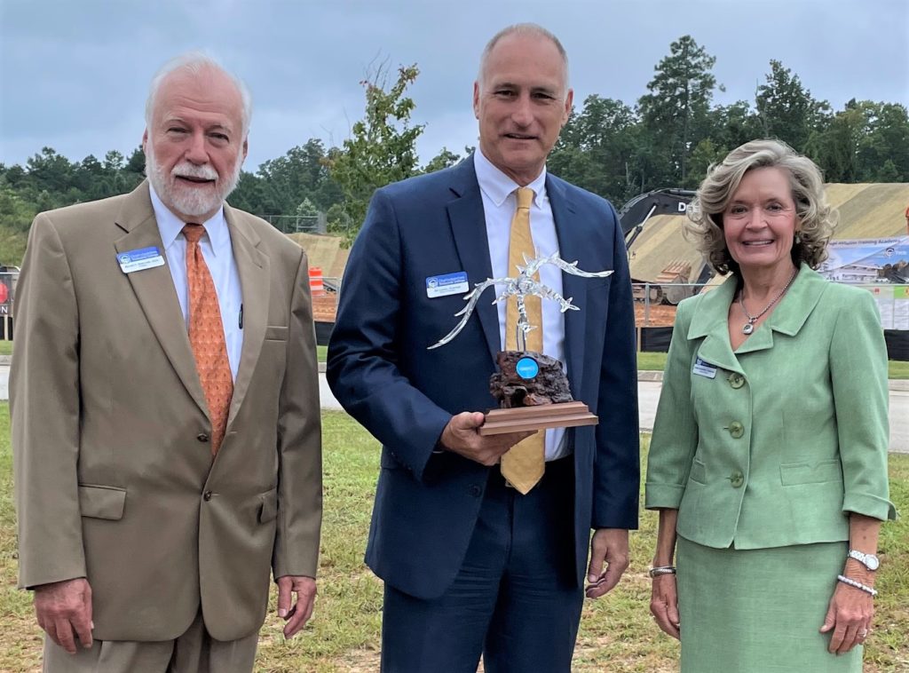 Dr. Newcomb is shown here with Jim Larson and Debbie Underkoffler