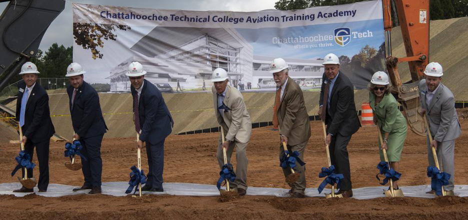 Groundbreaking ceremony event and officials posing with shovels