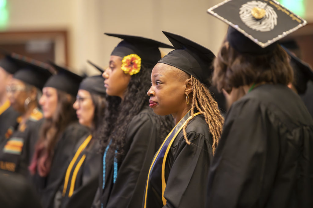 Chattahoochee Tech graduates stand at Commencement