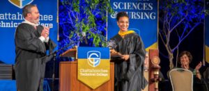 Jason Tanner presents award to Adrienne Baldwin at Commencement