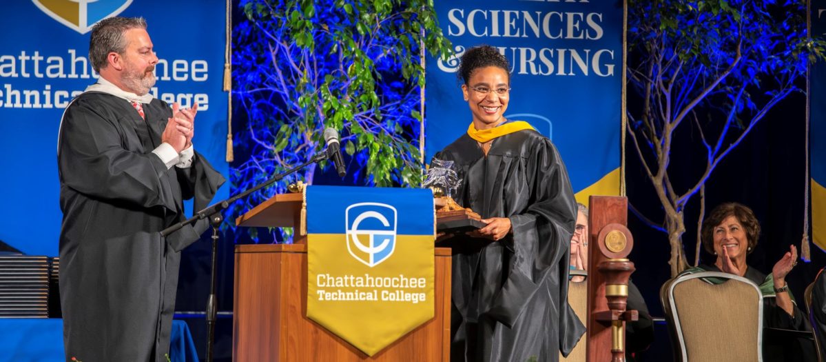 Jason Tanner presents award to Adrienne Baldwin at Commencement