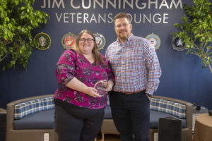 Allison Giddens and John Hudson of Wintech, inc. smiling with the award.