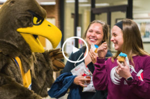 Students smiling as they meet Chattahoochee's Golden Eagle mascot