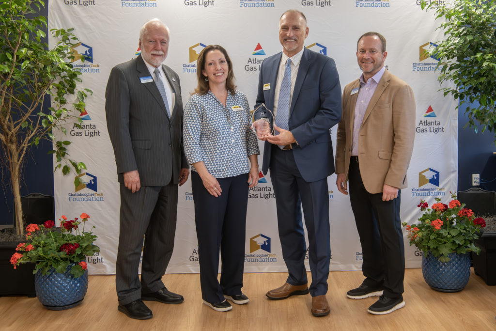 Yancey Brothers received the 2024 SPARK Workforce Industry Partner of the Year award. Shown here, l-r, are Dr. Ron Newcomb, Jennifer Kozel, Jim Larson, and Board of Trustees Chair Rick Kollhoff.