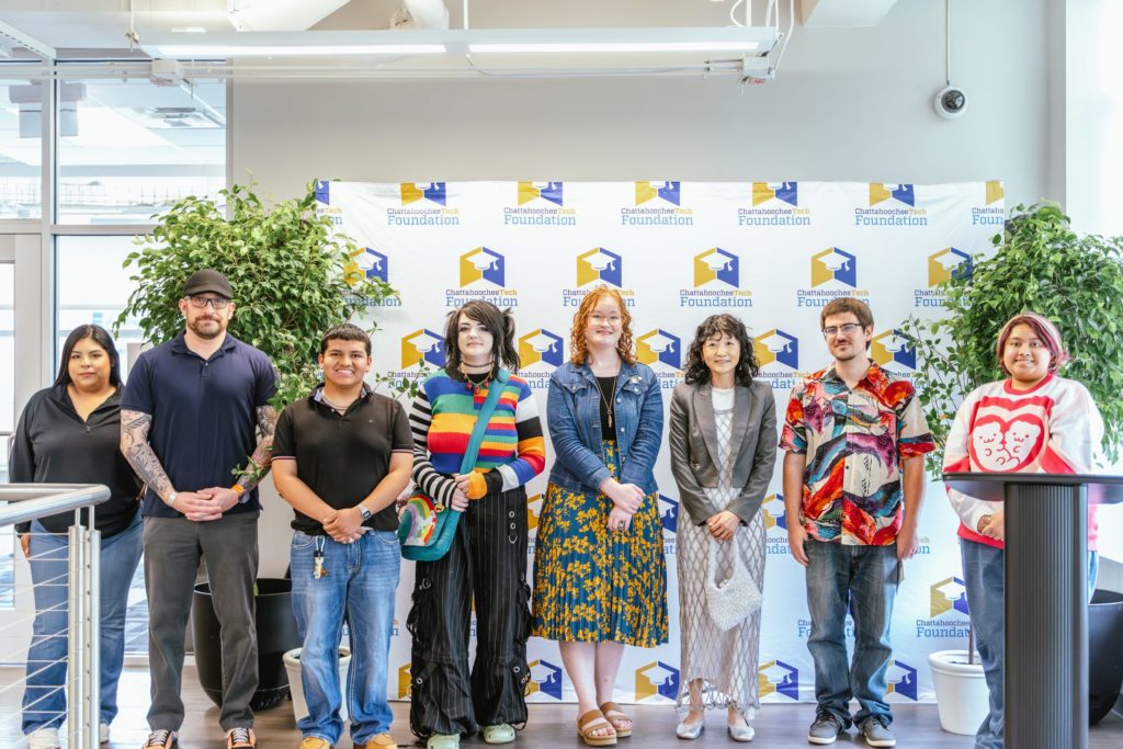 Eight of the Art Exhibit participants at the 2025 SPARK Workforce Awards are shown here