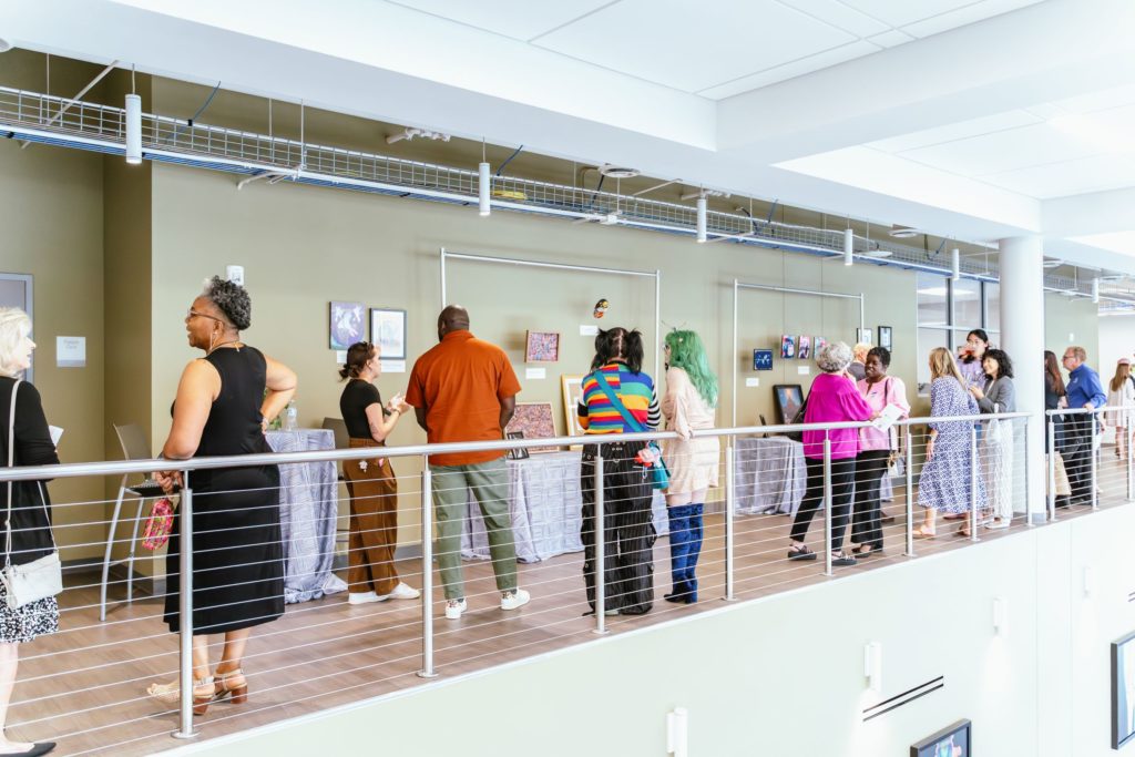 People standing near SPARK Workforce Awards Art Exhibit 2025