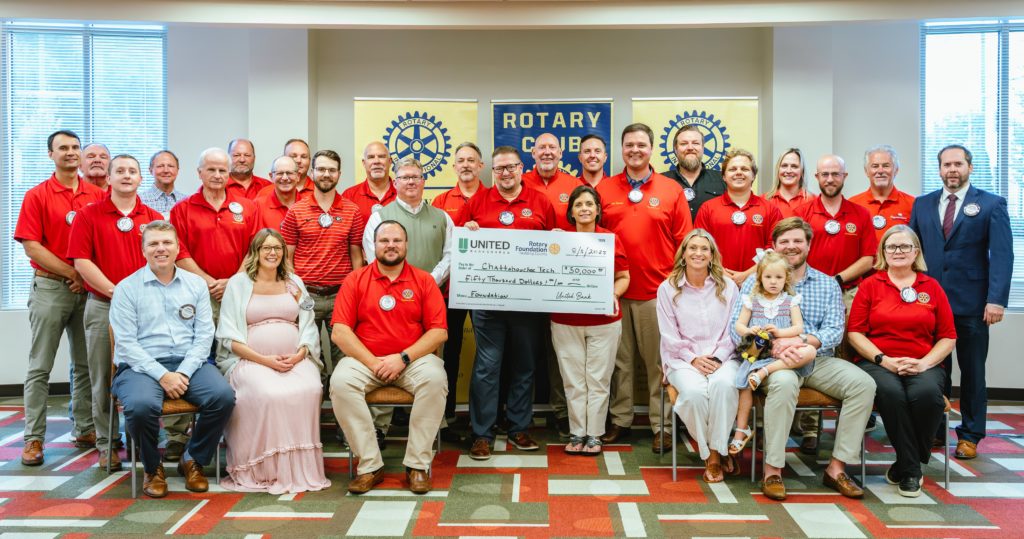 A large group of Paulding Rotary Club members is pictured here with the donation check.