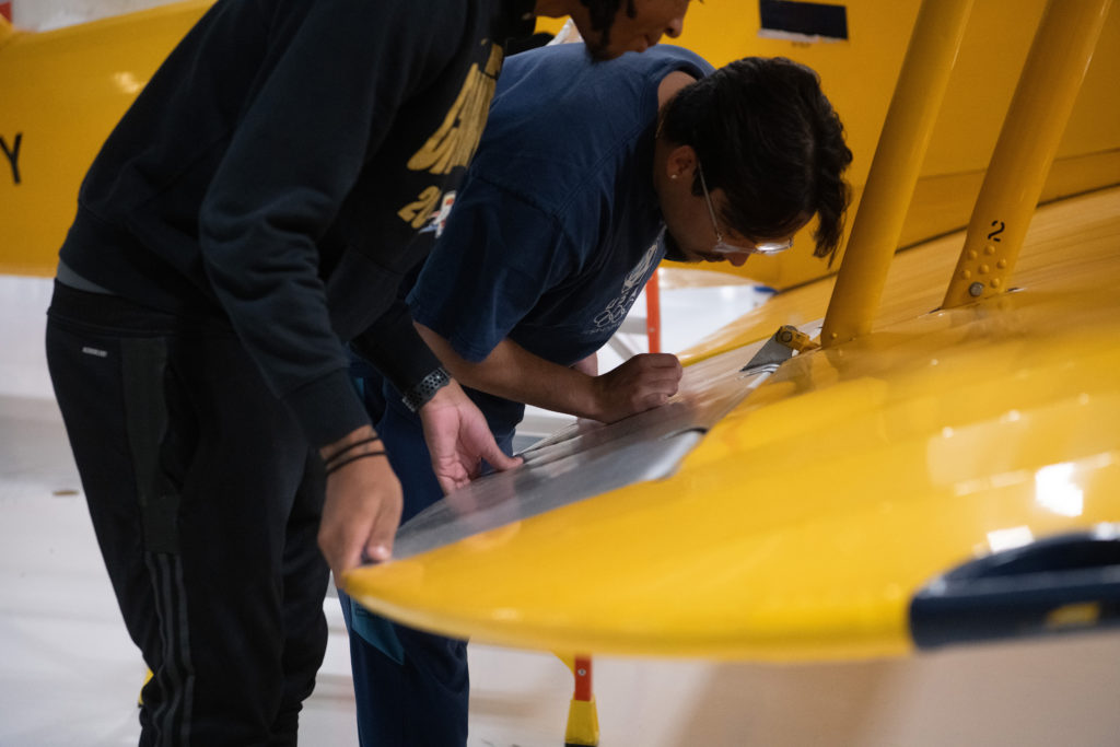 Chatt Tech students at the Aviation Training Academy working on a wing of the N3N airplane