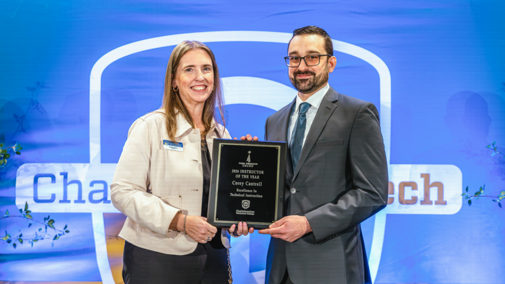 Corey Cantrell, Chattahoochee Tech's Instructor of the Year recipient, accepting the Rick Perkins Award (RPA) award with President Heather Pence.